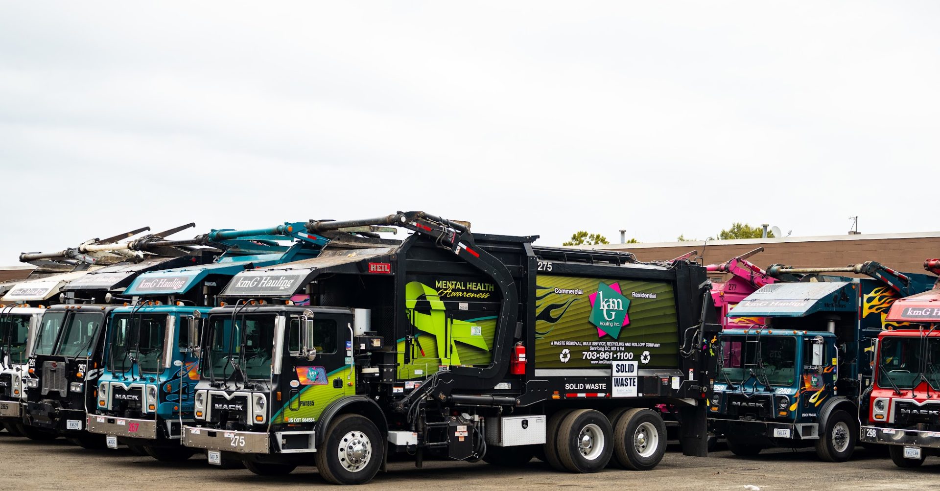 kmG Hauling fleet of trash and recycling trucks lined up